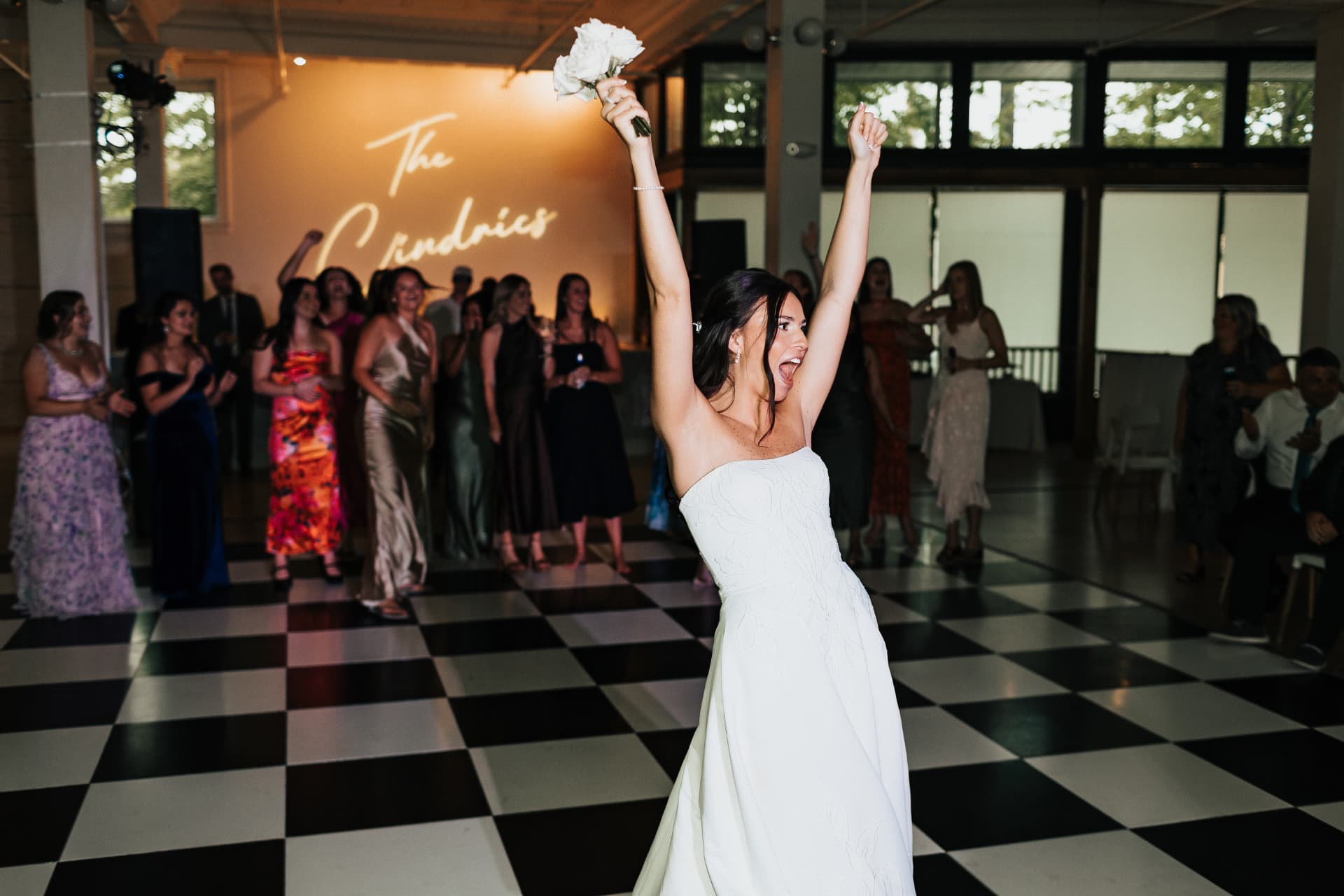 Bride celebrating on the dance floor at her wedding reception